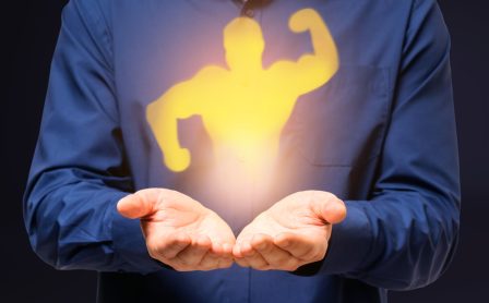 Abstract image of businessman hands holding strong muscle shadow on gray background. Confidence and strength concept