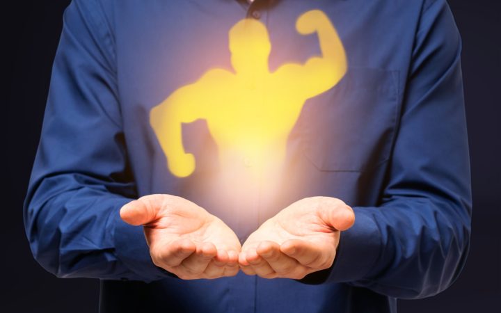 Abstract image of businessman hands holding strong muscle shadow on gray background. Confidence and strength concept